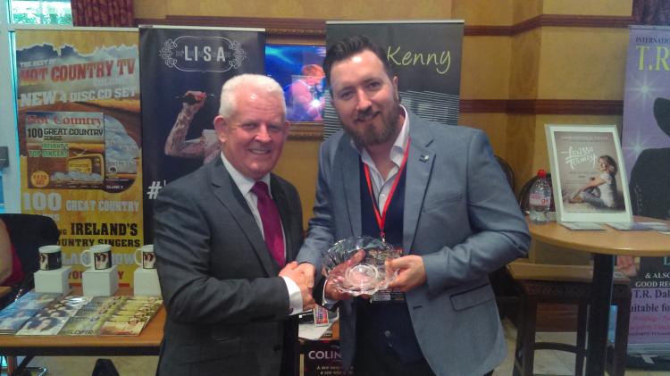 Hugh O'Brien presents Colin Kenny with his award