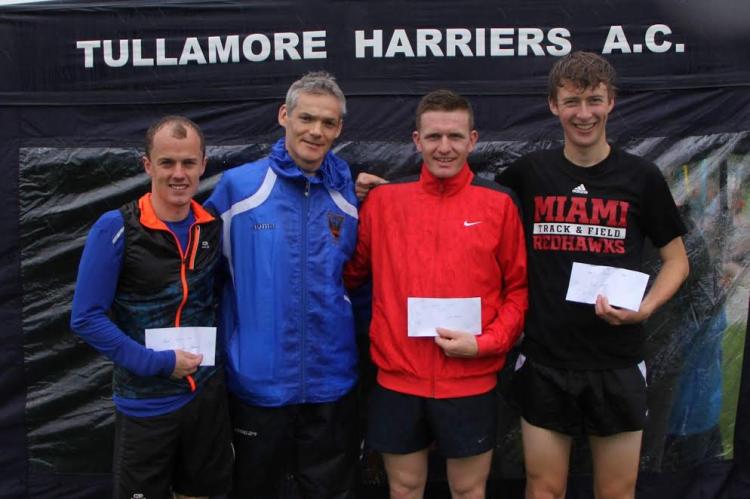 Darren Butler (Bank of Ireland) presenting the prizes to the 3000m medallists at the Bertie Quinn Track and Field. 
