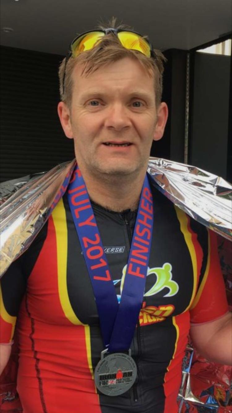 Michael Collins looking happy at the finish line in Bolton