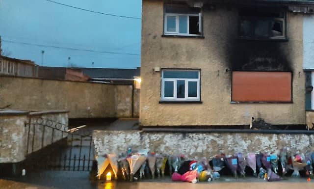 Flowers outside the house in Edenderry after it was firebombed in December