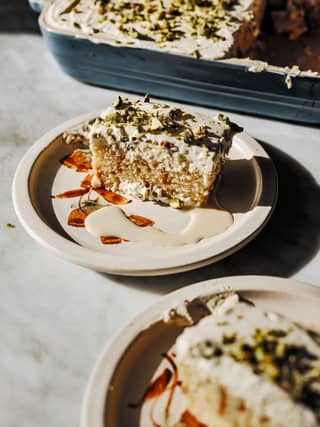 Ingredients(Serves 8-10)150ml milk397g can condensed milk350ml evaporated milk2tsp Somali tea spice24 Madeira cake slices (510g) or doolsho500ml double (heavy) or whipping cream100g icing (confectioners’) sugar1tsp vanilla bean paste100g crushed pistachiosEquipment: 23 x 30-cm/9 x 12-inch baking dish