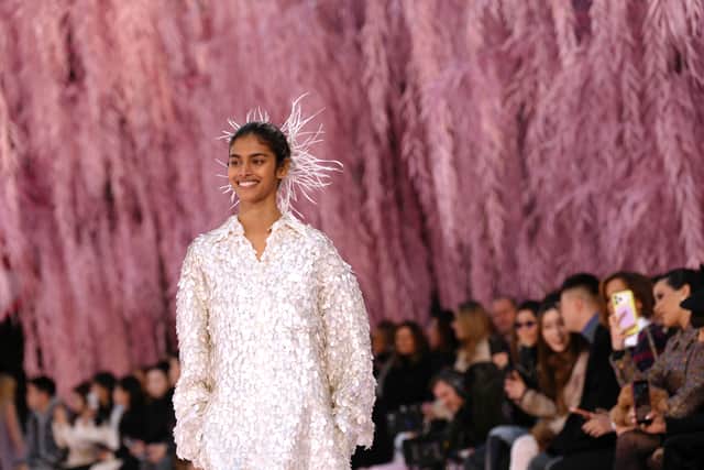 The closing look distilled Blazy’s vision. The bride, model Bhavitha Mandava, emerged in an oyster-white two-piece: a feathered midi skirt paired with a relaxed jacket, white plumes drifting through her hair.