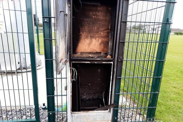 Below the cabinet which was badly damaged in the fire. An accelerant was believed to have been used.