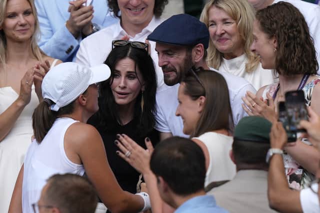 After landing a final backhand just inside the line, Swiatek collapsed to the court and then climbed up into the stands to celebrate with her supporters, who included Friends star Courteney Cox.