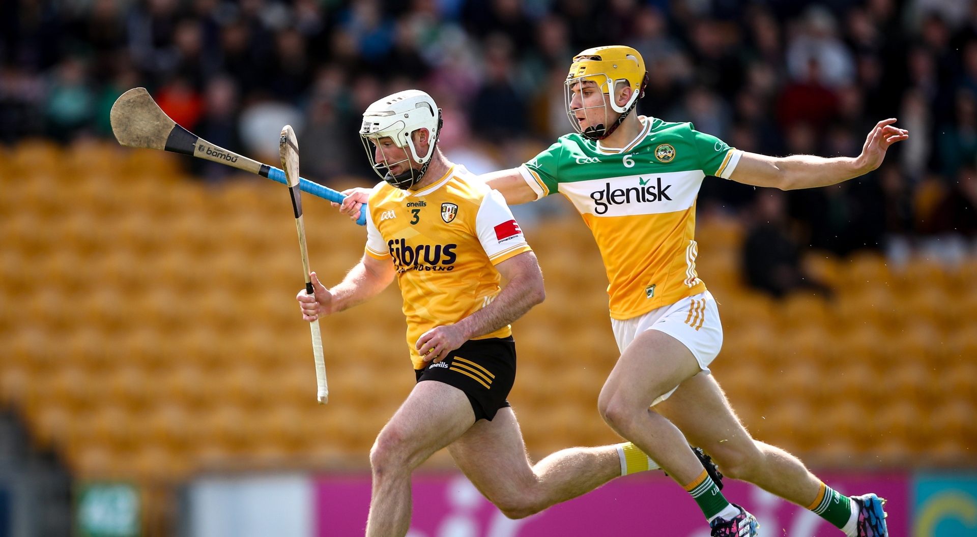 Donal Shirley makes life difficult for Paddy Burke, Antrim.