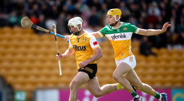 Donal Shirley makes life difficult for Paddy Burke, Antrim.