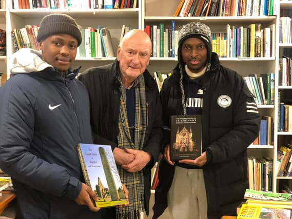 Samson, George and Codney pictured in Dimma's Books - the two books are some of George's best known works about Roscrea