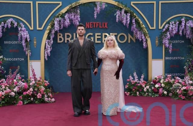 The pair posed together, Jessie, 34, wearing a black maxi dress and Thompson, 35, in light pink trousers and a white shirt.