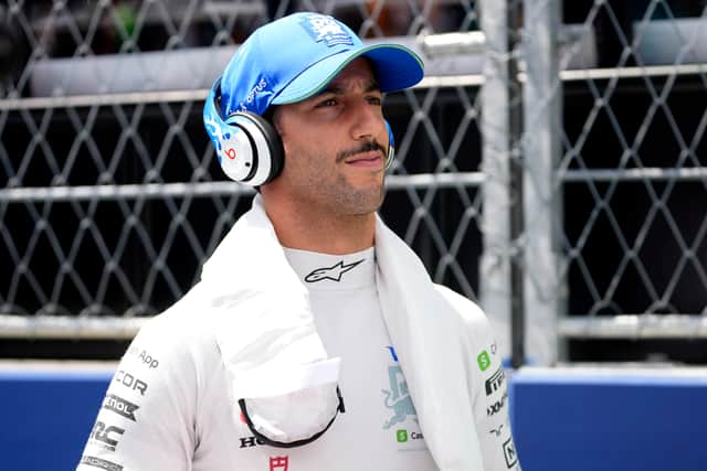 After stepping out of the machine that carried him to victory, Norris put down his yellow crash helmet before running and leaping into the arms of his mechanics.