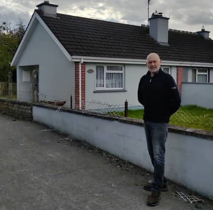 Sean Maher in front of a house in Presentation Place which has been idle for over a year .