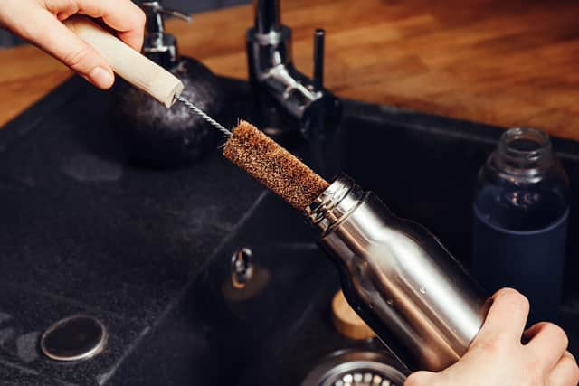 “Fill the bottle with hot soapy mixture and swill around, or leave to soak in a detergent mixture,” Hussain advises. “Remember to pay special attention to lids/caps and screw top regions – use a clean brush [to scrub them].”