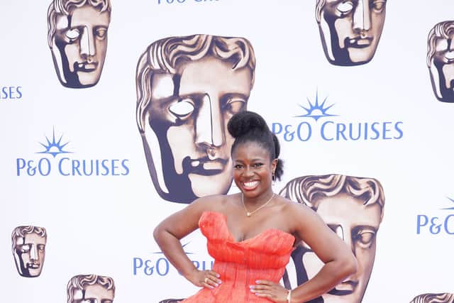 It had statement shoulders, white lace around the bodice and a red rose at the bottom of the deep-V neckline.