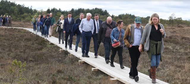 Some of the group which attended Friday's official opening. They are walking on the well-built, sturdy wooden planks of the boardwalk.