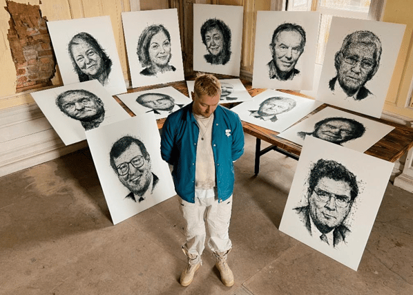 Shane Gillen pictured surrounded by his hand-drawn portraits. The artist spent part of his childhood in Tullamore