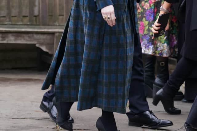 Singer Paloma Faith wore a purple jumper under a rust, floral-patterned dress with red shoes while Mad Men actress Christina Hendricks dressed in a navy and black checked coat-dress for the service.