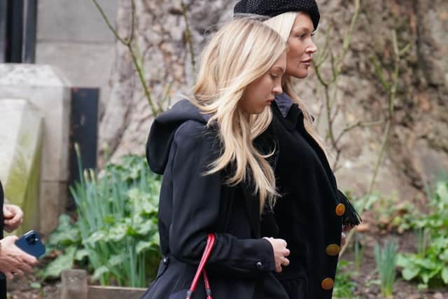 Supermodel Moss donned a black dress with a floral design and a black blazer and her daughter Lila Grace Moss Hack paired her outfit with a Westwood red bag.