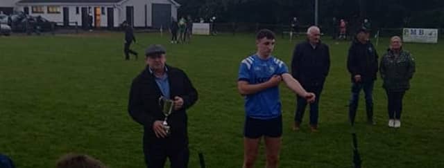 Morgan Tynan about to receive the cup from County Board vice chairman James Murphy