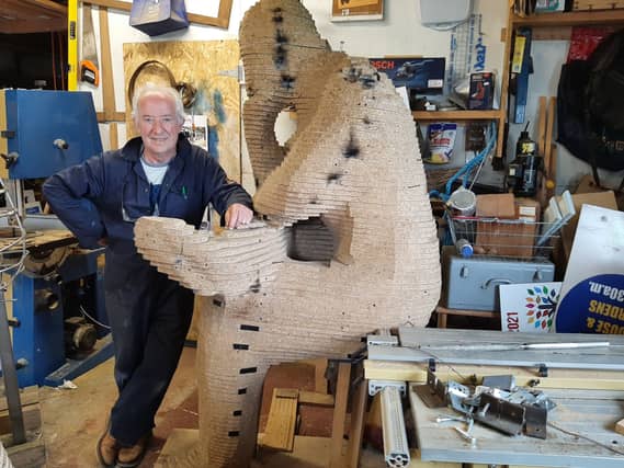 Tom Roche pictured in his Rhode workshop with the wooden mock-up depicting Concern founder Fr Jack Finucane
