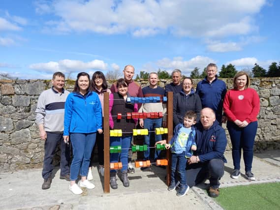 Shinrone Sensory Walkway Group and RSS workers who completed the project and their little helper at the opening of the Shinrone Sensory Touch area on Saturday last.