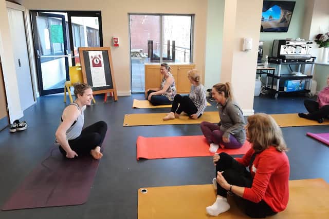 Below is Tina Kennedy yoga and mindfulness instructor showing some yoga stretches