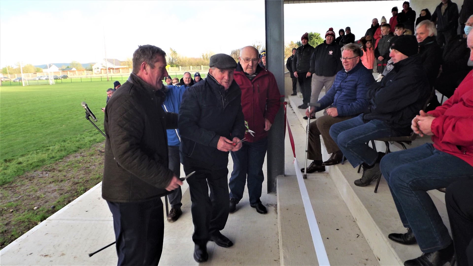 Mick Hogan (President) and Donie Moloney (Captain 1971 All-Ireland winning team), with Roscrea GAA Chairman Mark McLoughlin (on left), cutting the tape at the new stand at St Cronan's Park, Roscrea.