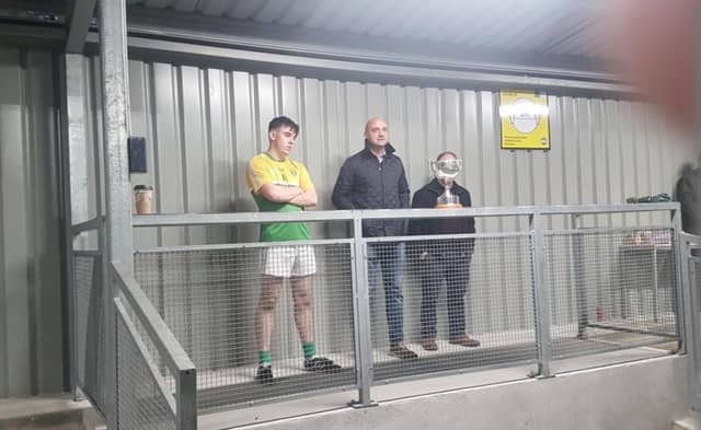 KK captain Shane Mulrooney about to receive the PJ Teehan Cup from Offaly GAA secretary Colm Cummins and John Teehan.