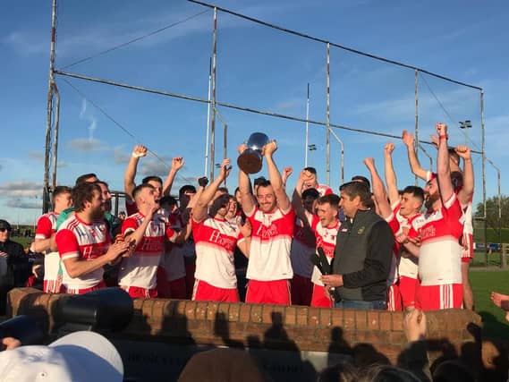 Eddie Bennett raises the IFC cup for Clonbullogue