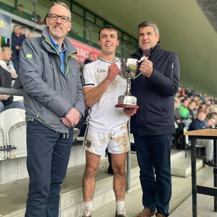 Clara captain, Colm Doyle receives the cup from sponsor Philip O'Brien of the Tullamore Court Hotel and Offaly GAA chairman Michael Duignan.