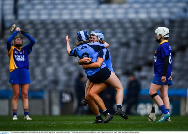 St Rynagh's players watch on as Gailltir celebrate victory in the 2019 All-Ireland intermediate camogie final last March.