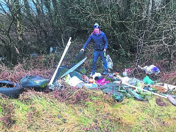 Pictured is Michael O'Meara with some of the illegal refuse being dumped on the much-loved beauty spot between Rathcabbin and Portumna, Redwood Bog.