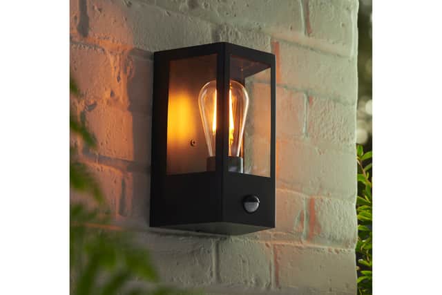“Instead, consider statement lanterns framing the doorway or discreet recessed downlights in the soffit.”