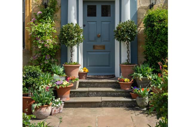 Introducing plants to your porch softens the lines, while adding colour and texture, says Threlfall. Perfectly placed for “creating the biophilic connection for a tranquil, welcoming atmosphere.”