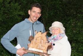 Kevin Minnock presented with the Hugo Smith Perpetual Trophy by Lucy Smith.