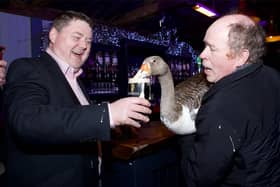 Concepta slugs a pint of Guinness at the parade presentation night in Tullamore with owner John Dolan and Cllr Shane Murray