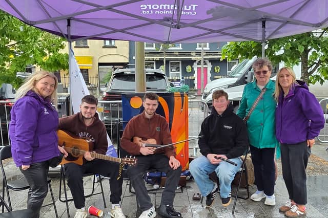 Musicians and Credit Union personnel at the street Fest