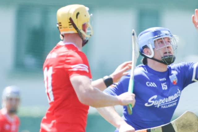 Diarmuid Egan wins the ball ahead of Killian Sampson
