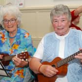 Pictured tuning their ukuleles at the July Rambling House hosted by Age Friendly Roscrea are Julie Thompson and Marie O'Meara. Photo: PJ Wright