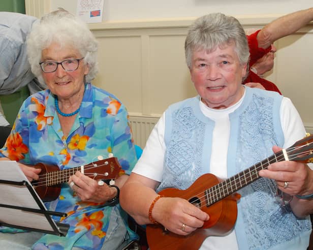 Pictured tuning their ukuleles at the July Rambling House hosted by Age Friendly Roscrea are Julie Thompson and Marie O'Meara. Photo: PJ Wright