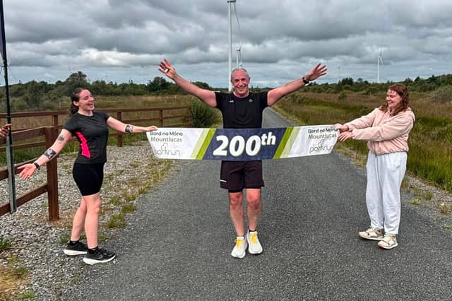 Gareth with his two daughters celebrate his 200th parkrun