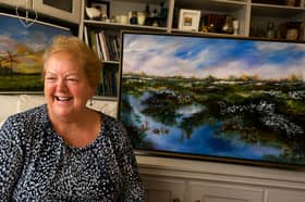 Esther Lambe with one of her paintings. 