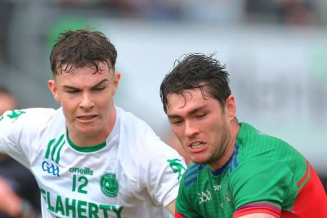 Andrew Delaney and Brian Carroll in a race for the ball