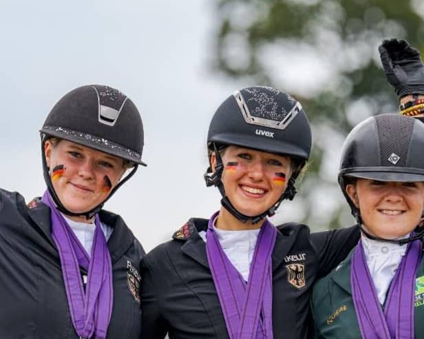 Maeve Deverall, right, proudly displays her medals