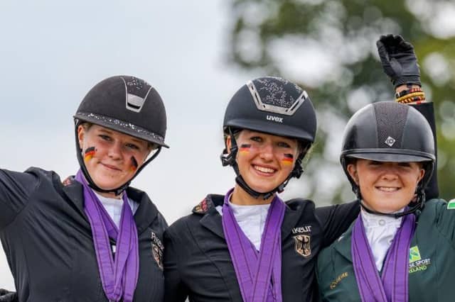 Maeve Deverall, right, proudly displays her medals