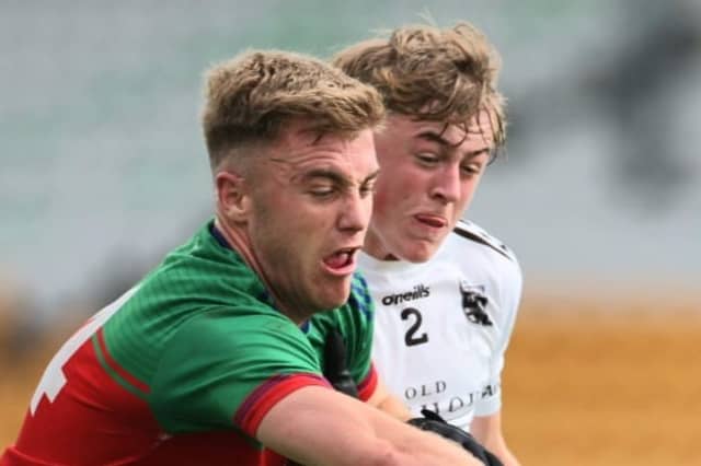 Jack Bryant grabs the ball ahead of Callum Bracken.