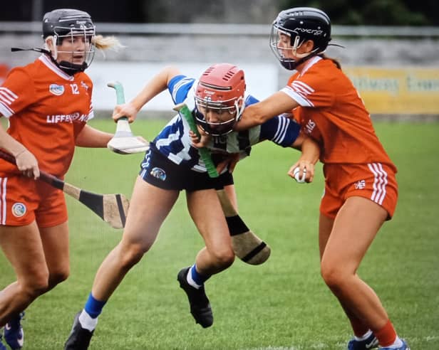 St Cillian's Caoimhe Donovan under pressure from two Shinrone players in the Senior A camogie final.