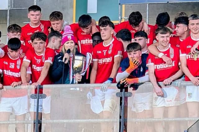 Edenderry captain Ruari Carroll about to be presented with the MFC Cup by Offaly GAA’s Niamh Clarke