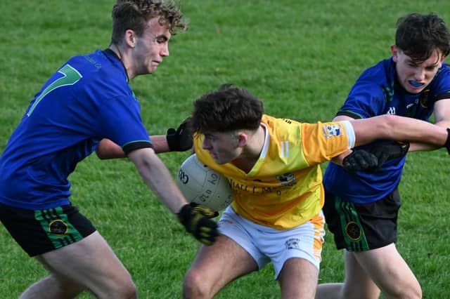 Deasun McNamee holds onto the ball for St Vincent's despite the best efforts of Barry Bradly and Jack McGuinness