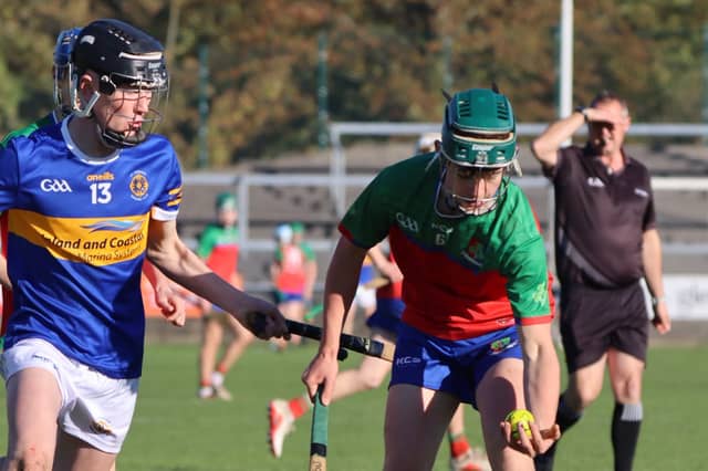 Cillian Moran grabs the ball ahead of Gavin Deverty