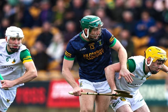 Thomas Geraghy is tackled by Ross Ravenhill and Cian Kinnarney