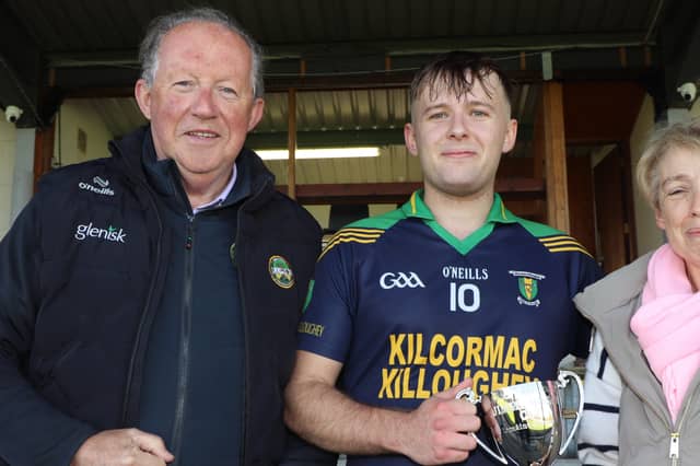 Tom Parlon presents the Jimmy Hogan cup to Kilcormac Killoughey captain Aaron O'Kelly with Edel Hogan-Hoctor